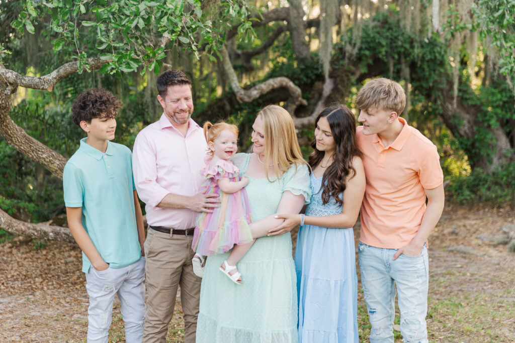 family with teens and toddler pose during family photo session