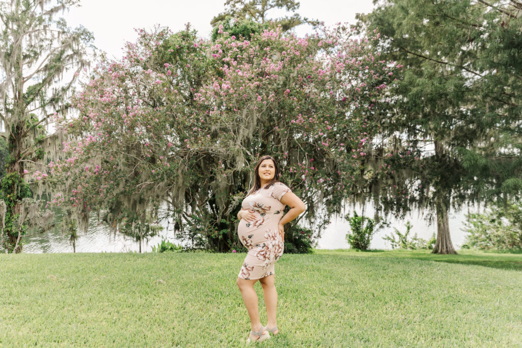 mommy-to-be showing off her baby bump posing for maternity photo session