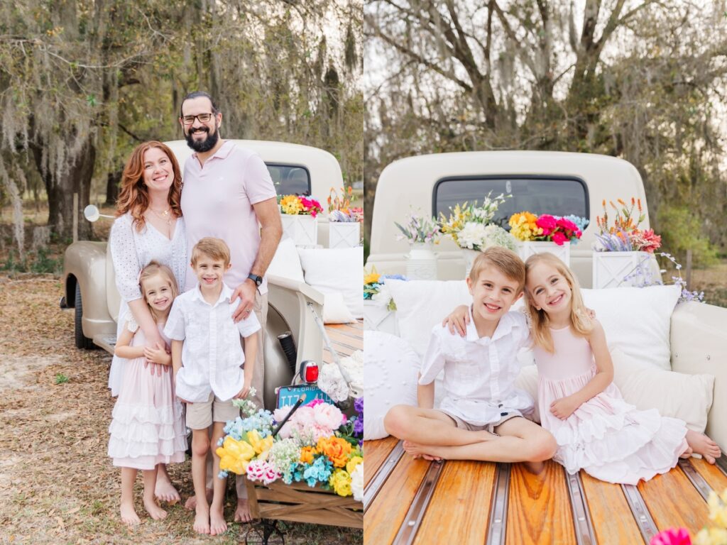 family posing by vintage truck and kids sitting in bed of truck