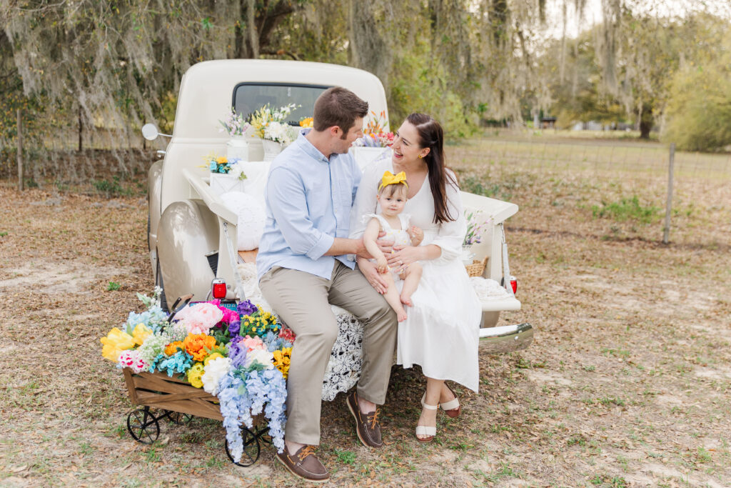 candid family photo in bed of truck full of florals for spring mini session